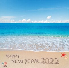 Fototapeta na wymiar happy new year 2022 written on the sand