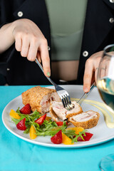 Chicken cordon bleu schnitzel, meat wrapped around ham and cheese