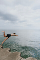 man diving into lake michigan