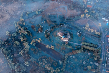 Aerial view of the Olesko castle. A very beautiful castle in foggy dark weather. Lviv region, Ukraine. Tourism, travel.