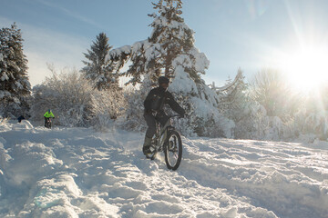 Snowy descent with a mountain bike. Snow downhill with bike, mtb action in winter, with deep snow...