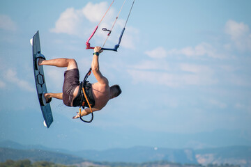 Kitesurfer athlete doing double backroll on air