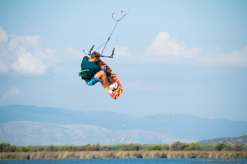 Kitesurfer athlete doing double backroll on air