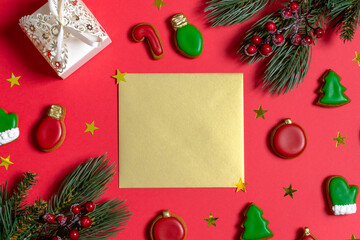 New Year's Flatlay spruce branches gift gingerbread golden paper for writing in the center copy space 