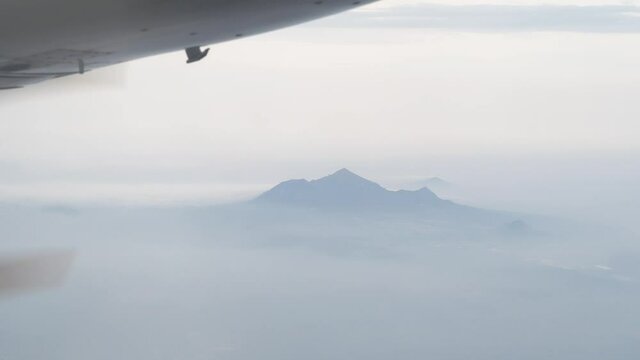 .Mount-laccolite Beshtau Pyatigorsk from a great height. Shooting through the window of the aircraft visible mountain and spinning propeller.