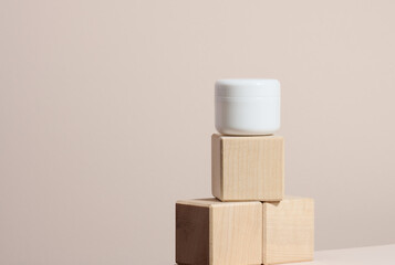 white jar for cosmetics on a beige table. Packaging for cream, gel, serum, advertising and product promotion, mock up