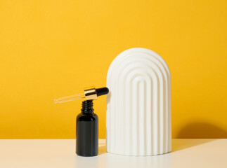 brown glass bottle with pipette stands on a white table. Cosmetics SPA branding. Packaging for gel, serum, advertising and product promotion, mock up