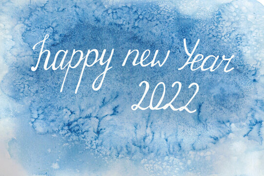 blue watercolor background . handwritten lettering happy new year 2022 . congratulations , a blank on a blurry spot , blue frost . congratulations , design