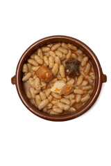 Close up of a terracotta dish with Asturian fabada, a typical Spanish bean stew, on a white background.