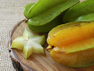 Tasty carambola fruit on wooden table.