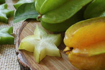 Tasty carambola fruit on wooden table.