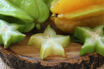 Tasty carambola fruit on wooden table.