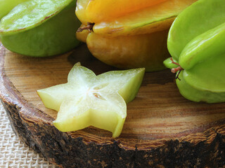 Tasty carambola fruit on wooden table.
