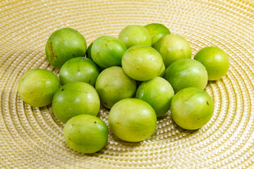 Ripe umbu (Spondias tuberosa) fruits on rustic surface and selective focus