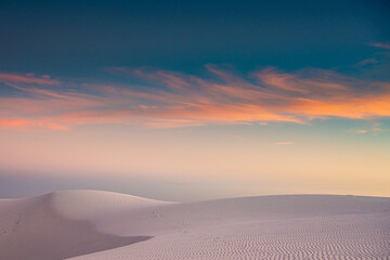 Fototapeta na wymiar Whispy Pastel Clouds At Sunset Over White Sands
