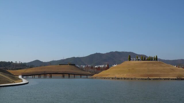 Man-made Lake Garden skyline in Suncheonman Bay National Garden, Suncheon South Korea. Bridge of Dreams, Haeryeong, Bonghwa Hills against clear blue sky with Mountain on background