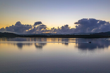 Aerial sunrise over the bay with clouds and reflections
