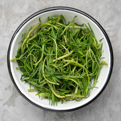 Bunch of fresh rosemary on a gray background