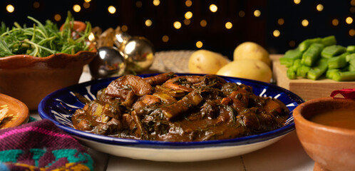 Mexican romeritos with mole sauce and shrimp on a white background