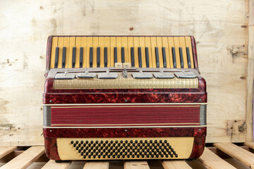 Old red accordion covered with dust