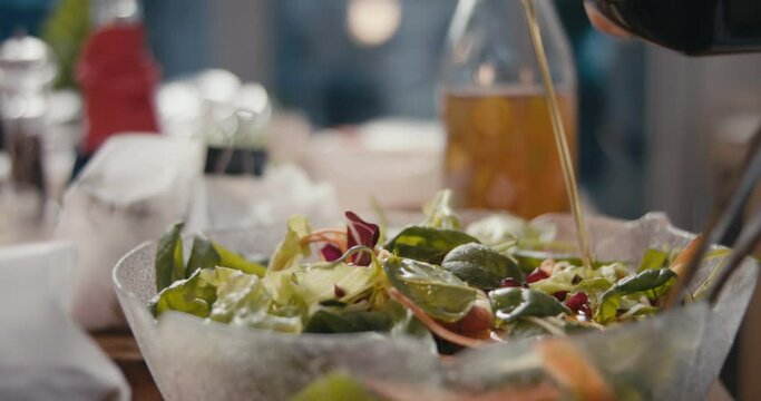 Olive oil salad dressing pour preparing dinner kitchen in slow motion