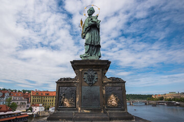 Fototapeta premium View of the famous statue of John of Nepomuk (Jan Nepomucký) at Charles Bridge - Prague, Czech Republic