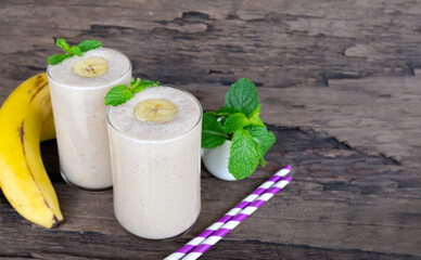 Banana fresh cocktail vanilla smoothies  fruit juice beverage healthy the taste yummy in glass drink episode good morning on wooden background.