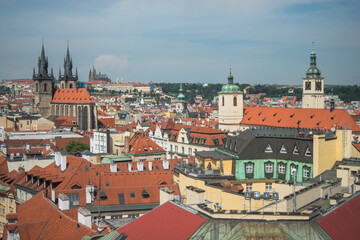 Naklejka na ściany i meble Cityscape of Prague and many of it's famous buildings such as the Church of Our Lady before Týn and Prague Castle from a viewpoint at the Powder Tower - Prague, Czech Republic