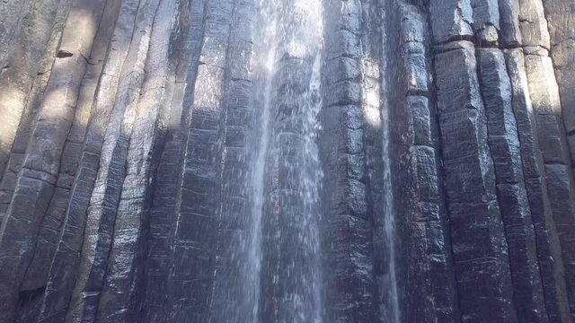 Waterfall from the basalt prisms geological formation, San Miguel Regla, Mexico