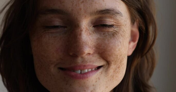 Close up cropped view lovely freckled face of attractive woman look at camera. 20s authentic female having wide toothy smile advertise dental services, natural beauty, young generation person portrait