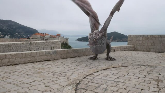 Realistic Dragon flying, landing and roaring on the Lovrijenac Fortress in Dubrovnik. Game of Thrones Mythical Location.