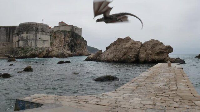 Realistic Dragon Roaring and flying over Dubrovnik Dock towards the Bokar Fort. Game of Thrones Mythical Location.
