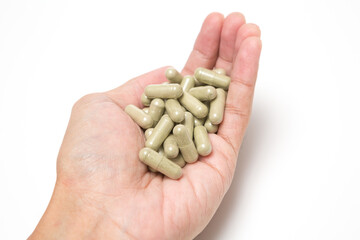 Selective focus of Many medicine capsules on hand on  white background
