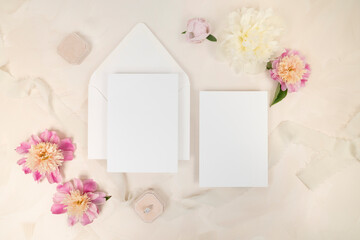 Beautiful romantic bridal blank stationery invitation flat lay with fresh flowers and velvet ring box
