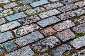 Cobblestone street texture. Regular shapes of cobblestone road, abstract background of old cobblestone pavement close-up.