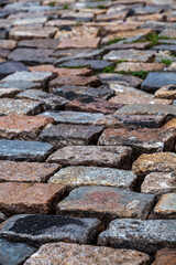 Cobblestone street texture. Regular shapes of cobblestone road, abstract background of old cobblestone pavement close-up.