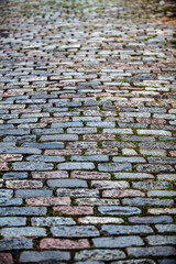 Cobblestone street texture. Regular shapes of cobblestone road, abstract background of old cobblestone pavement close-up.