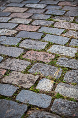 Cobblestone street texture. Regular shapes of cobblestone road, abstract background of old cobblestone pavement close-up.