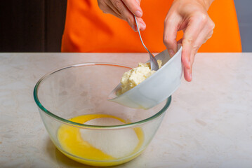sugar and sour cream are added to the melted butter