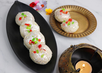 Rasmalai or Malai Sandwich, Roshmolai, Rasamalei is very popular Indian dessert. A sweet malai stuffing inside Rasgulla. It's a sweet delicacy made with Indian cottage cheese or chenna. Copy space.
