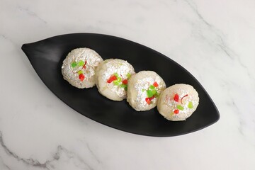 Rasmalai or Malai Sandwich, Roshmolai, Rasamalei is very popular Indian dessert. A sweet malai stuffing inside Rasgulla. It's a sweet delicacy made with Indian cottage cheese or chenna. Copy space.