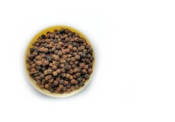 Pile of black pepper corns isolated.