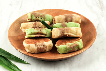 Pukis Pandan Chocolate is a Popular Traditional Snack in Indonesia or Jajan Pasar. This Snack is One Varian of Jajanan Pasar. Copy Space on White Background