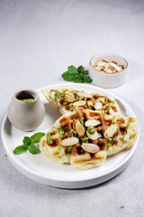 Homemade Croissant Waffle or Croffle with greentea sauce and chopped almond, easy making for breakfast