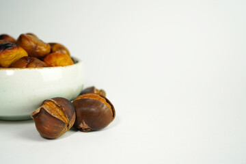 roasted chestnuts on a white background, winter