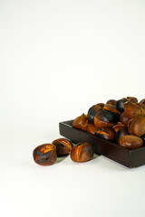 roasted chestnuts on a white background, winter
