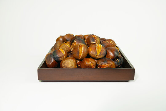roasted chestnuts on a white background, winter