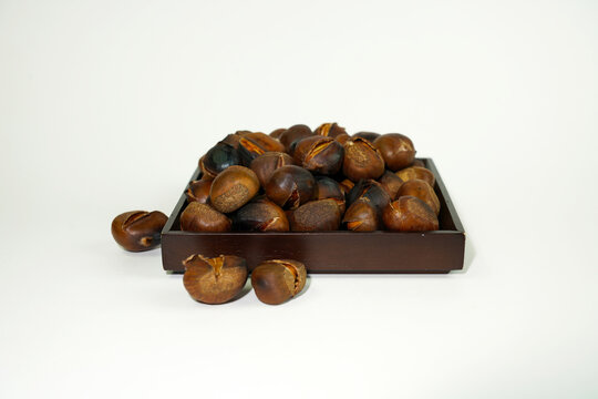 roasted chestnuts on a white background, winter