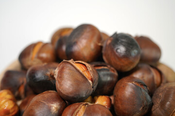 roasted chestnuts on a white background, winter
