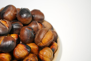 roasted chestnuts on a white background, winter